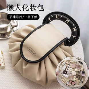 Capacious cosmetic bag, shoulder bag, handheld storage system for traveling, drawstring