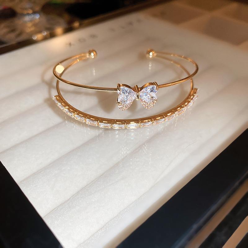 Golden white bracelet with bow