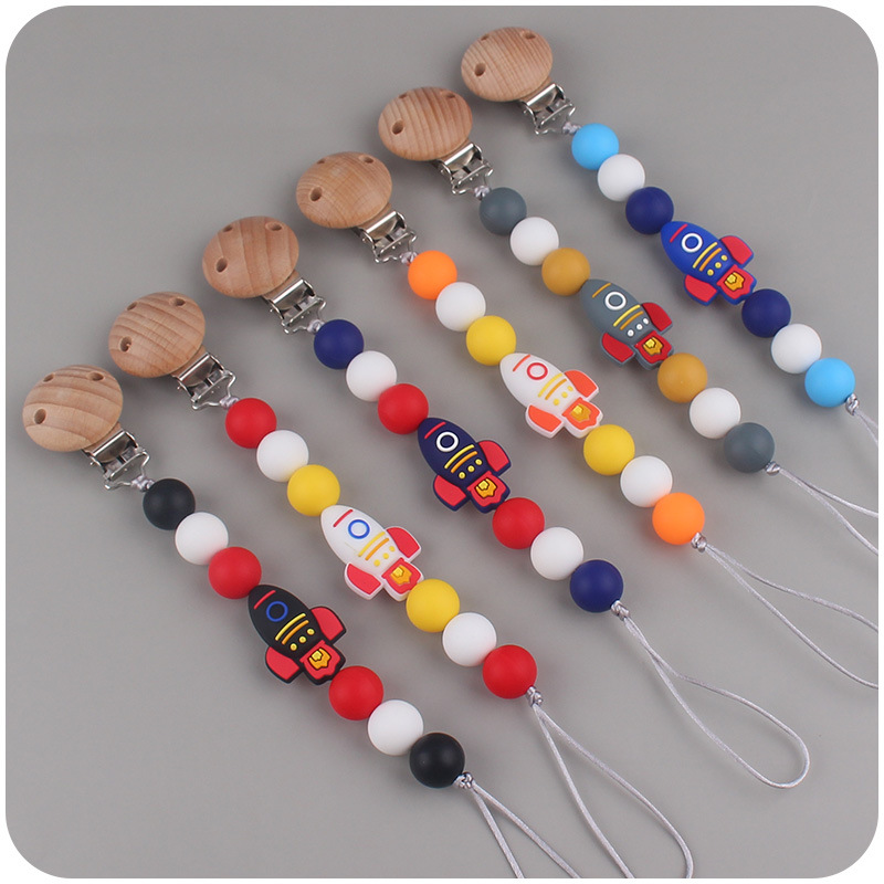 Nuevos suministros para bebés cohete de dibujos animados pequeño mordedor creativo DIY silicona mordedura molar Cadena de pezón cadena anti-caída