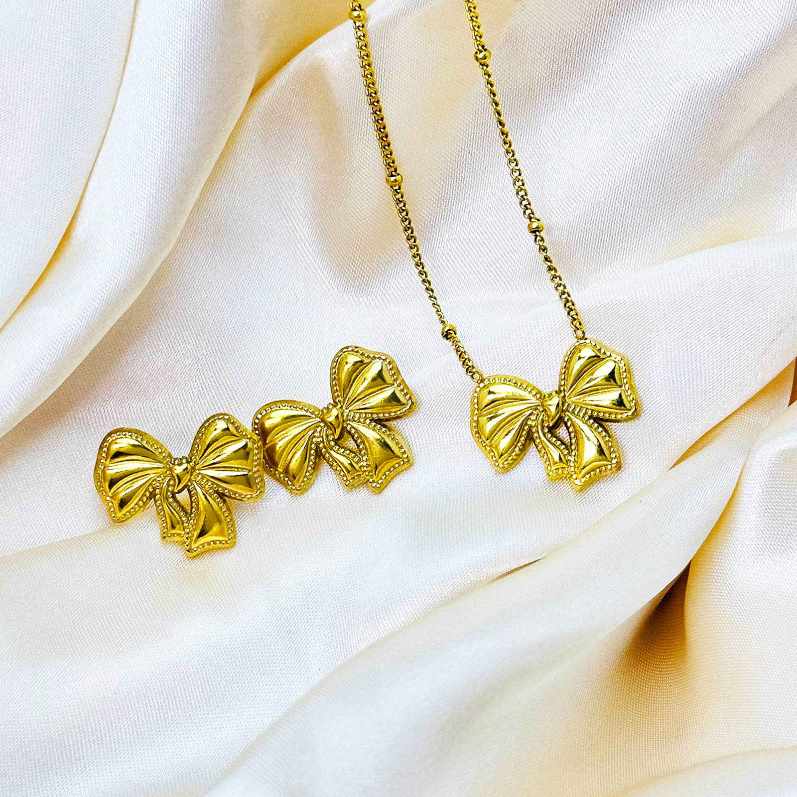 Bow set pendientes ligero lujoso estilo transfronterizo colgante de acero de titanio no decolor 18K joyas de oro ins