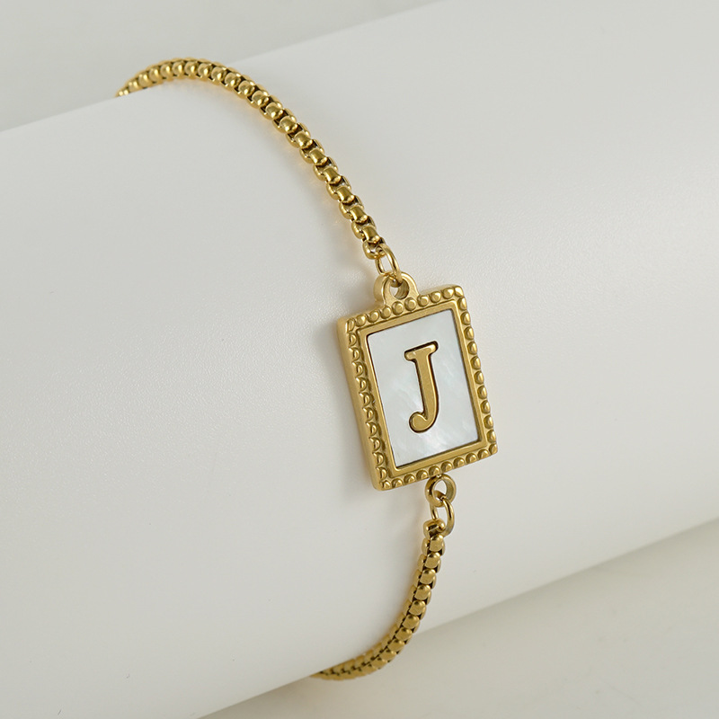 Nuevo europeo y americano transfronterizo de acero inoxidable 26 letras inglesas Shell pulsera personalidad todo partido titanio acero 18K cremallera