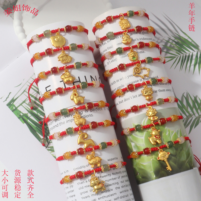Trendy red string bracelet for the Year of the Sheep, featuring a small sheep charm and a jade-like design, with a pull-string closure, perfect for the New Year. Wholesale available