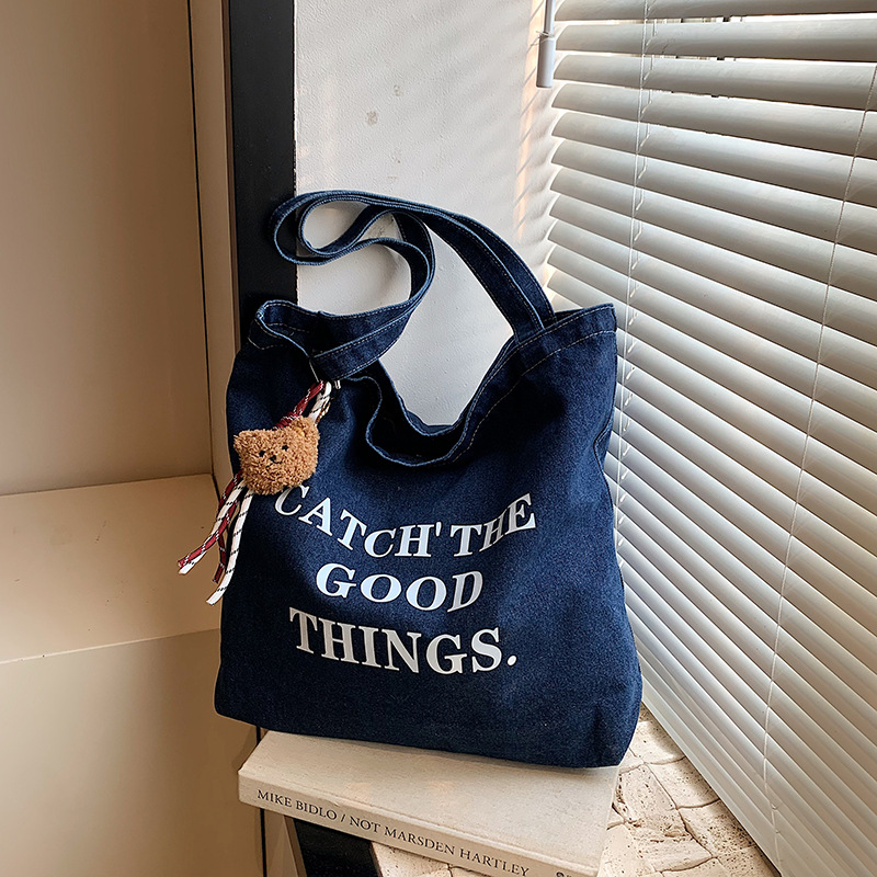 Bolsa de vaquín casual americana para estudiantes universitarios de clase viaje de compras letras de viento perezoso portátil gran capacidad bolso de hombro