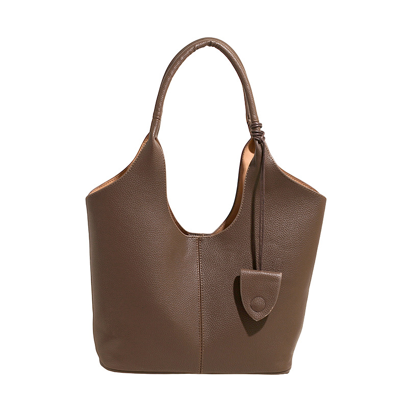 Versión coreana del bolso de alta capacidad 2025 nuevo bolso de cubo de todo fósforo de moda bolso de hombro simple bolso de axila de color sólido
