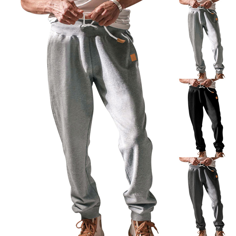 Nuevo nuevo hombre europeo y americano primavera y otoño pantalones deportivos casuales hombre correa suelta color sólido pantalones de tendencia de pies pequeños al por mayor