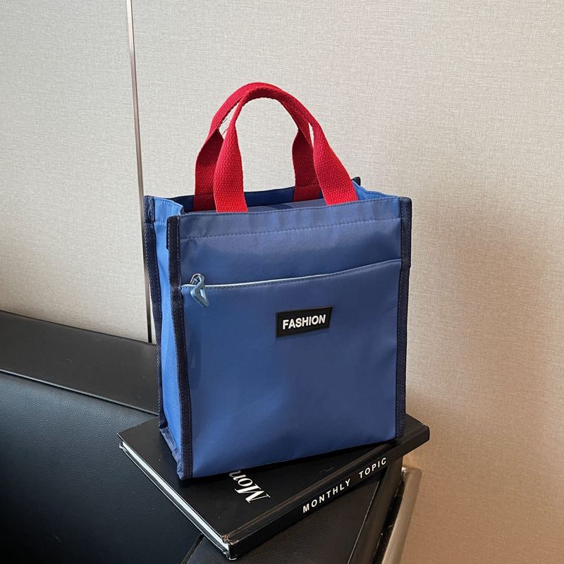 Moda coreana nueva serie de gran capacidad bolsas escolares portátiles de otoño 2024 bolsas de botellas impermeables Oxford