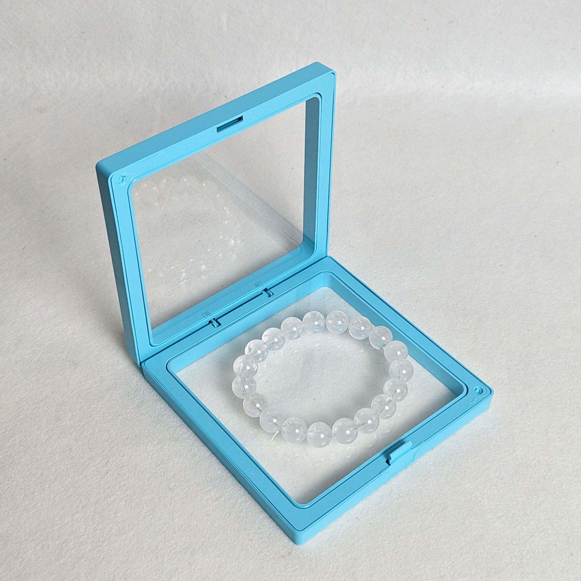 Sky blue pe film box; length and width 9*9cm, thickness 2cm