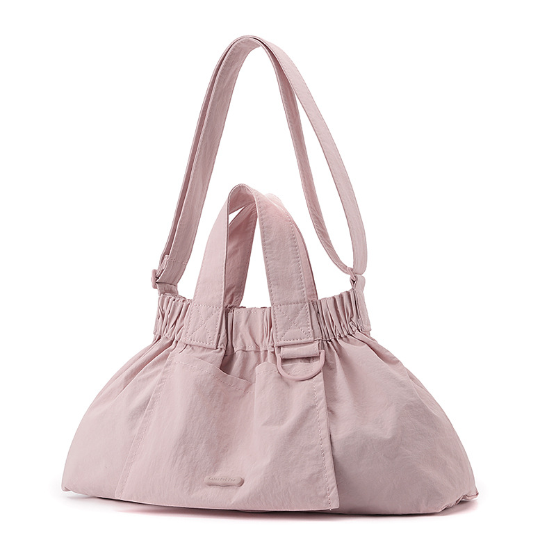 El nuevo diseño de nicho coreano del comercio exterior tiene un sentido del conocimiento de embarque a mano y una bolsa de mujer en el hombro es ligera, casual y plegable.