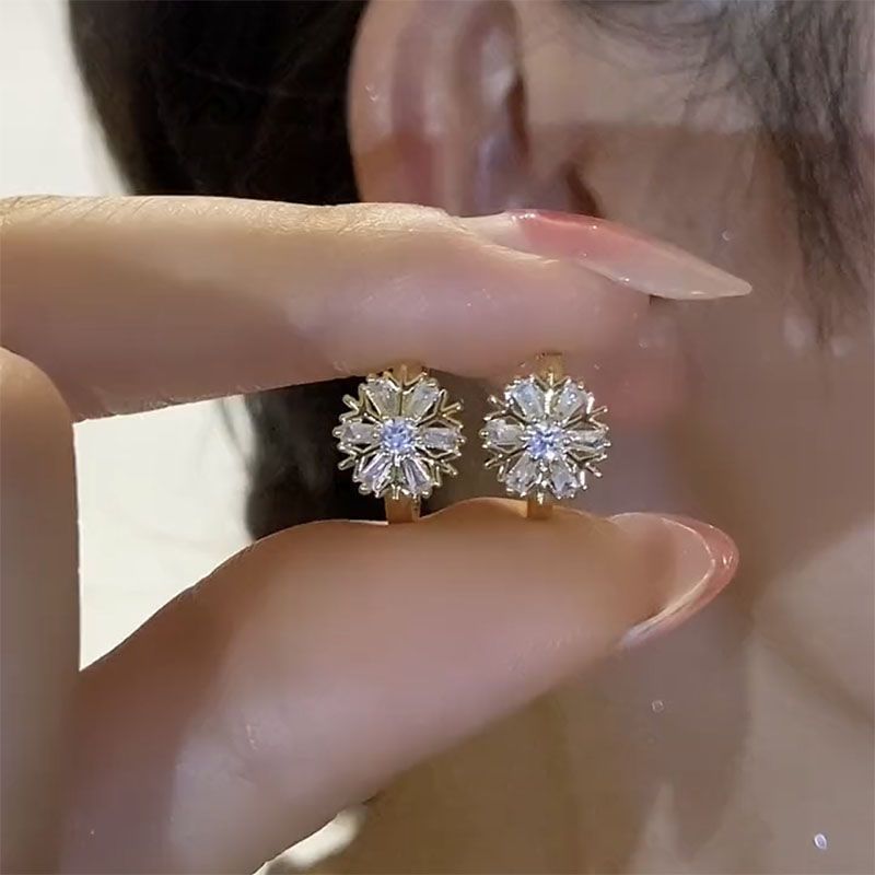 Small design sophisticated elegant earrings solar-powered, with snowflakes, diamond encrusted, light luxury style