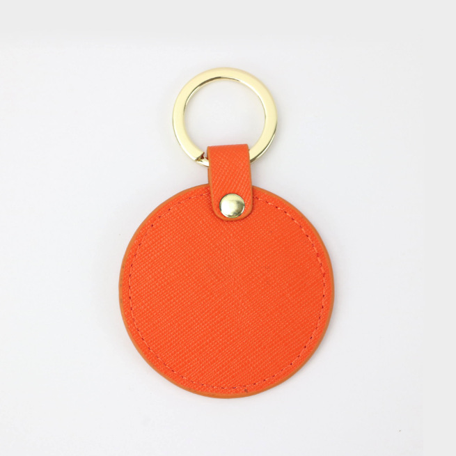 Llavero redondo de cuero genuino personalizado creativo simple colgante hombres y mujeres pequeño exquisito pequeño regalo al por mayor todo a juego