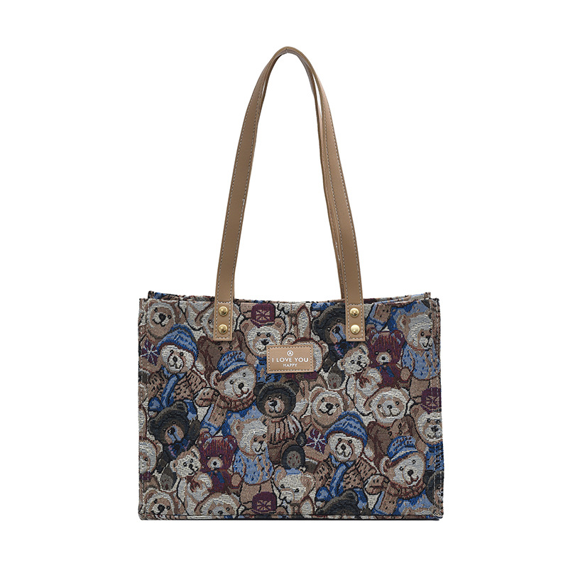 Bolsa de lona impresa de dibujos animados para mujeres 2024 nueva bolsa de gran capacidad, bolsa de hombro de viaje casual versátil