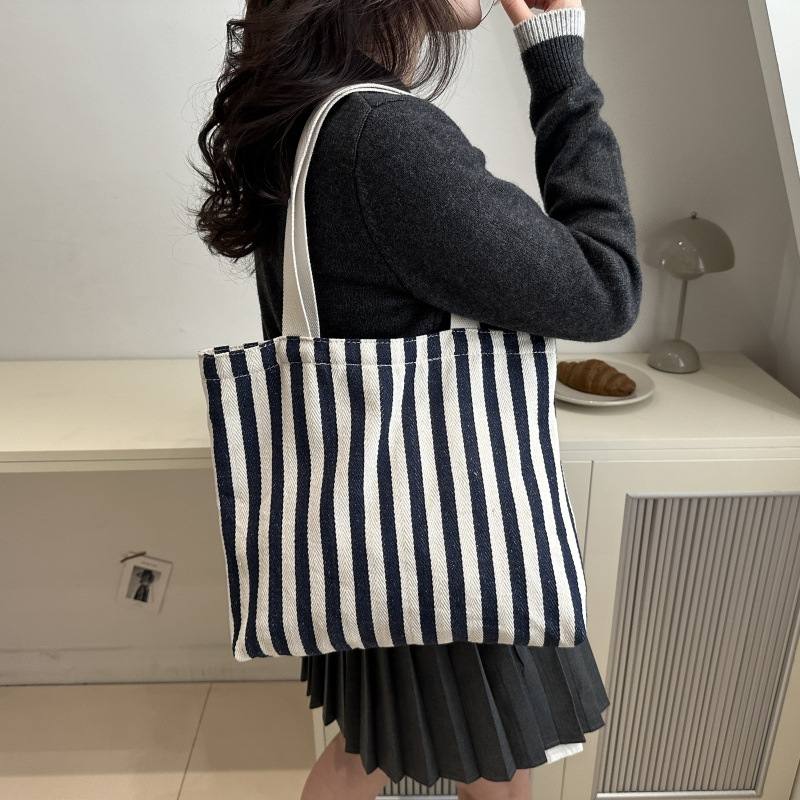 The new cross-border vertical striped commuter tote bag, hand-held shoulder bag, is fashionable and has a large capacity. It features an InS-style simple letter sail undefined