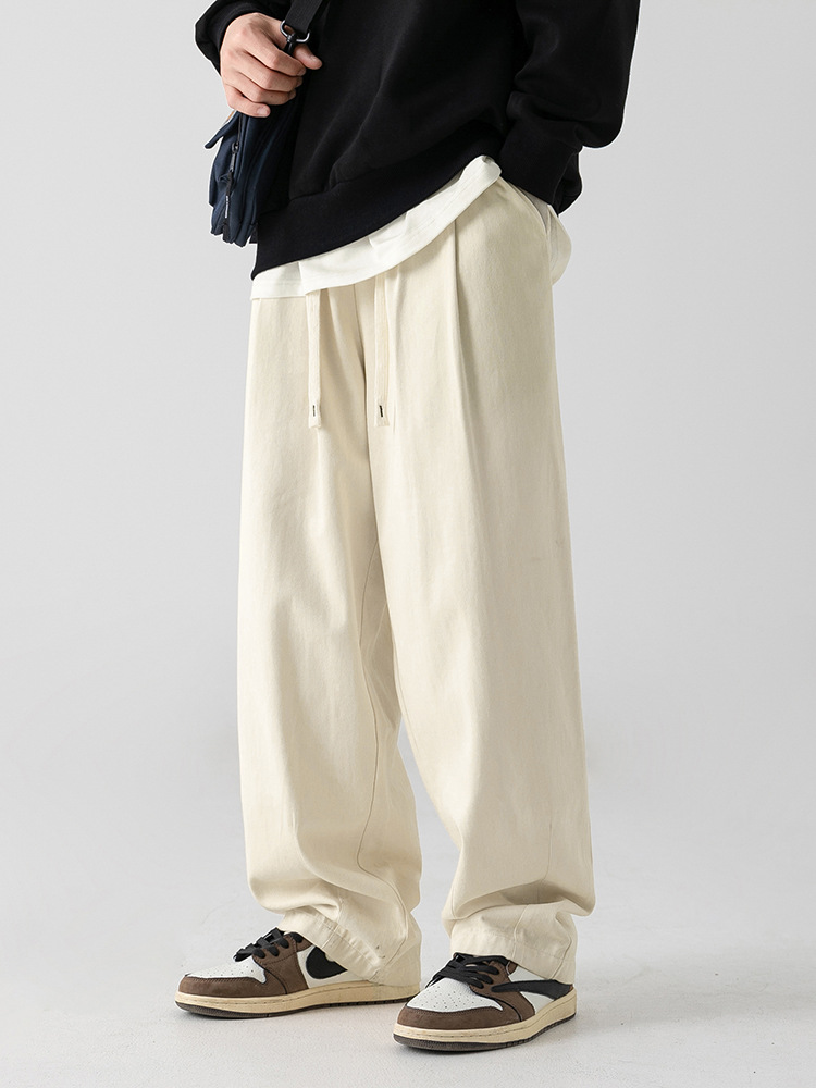 Pantalones casuales sueltos lavados en arena retro japoneses, estilo de primavera para hombres, marca de moda, diseño plisado tridimensional de todo fósforo más pantalones de terciopelo