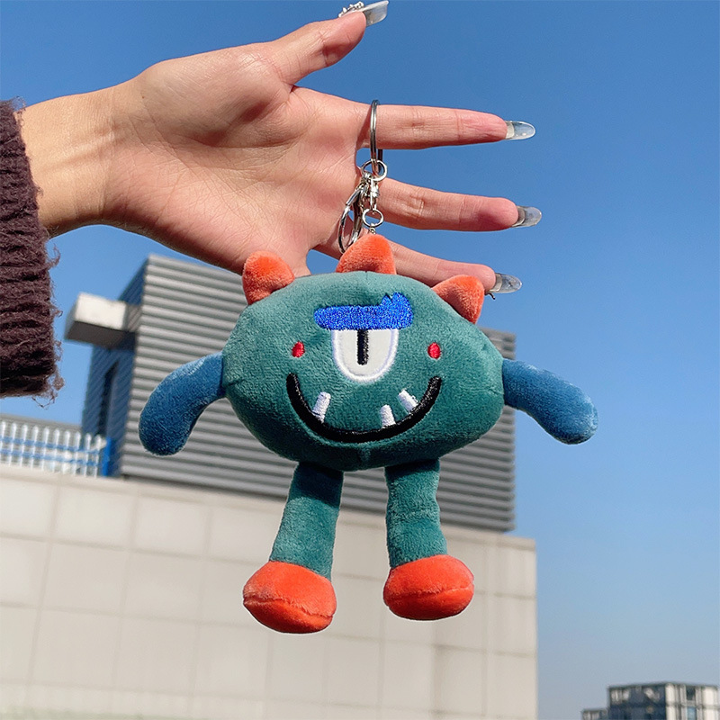アニメのかわいいおかしな目の小さい怪獣のぬいぐるみのペンダントの学生のぬいぐるみのバッグのキーホルダーの飾り|undefined
