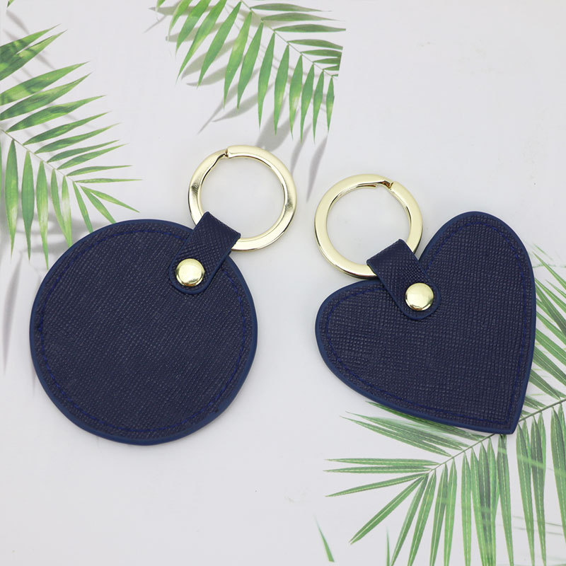 Llavero redondo de cuero genuino personalizado creativo simple colgante hombres y mujeres pequeño exquisito pequeño regalo al por mayor todo a juego