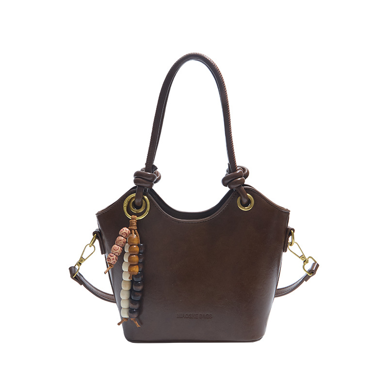 Coreano retro cuero suave bolso de cubo de mano 2025 nuevo estilo de alto nivel bolso de hombro de moda bolso de viaje para mujeres