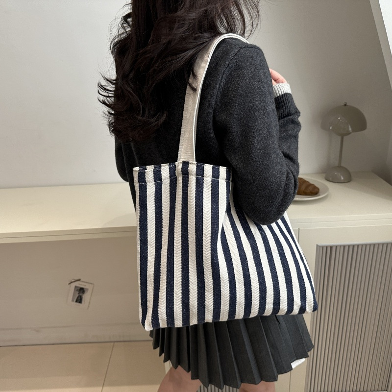 The new cross-border vertical striped commuter tote bag, hand-held shoulder bag, is fashionable and has a large capacity. It features an InS-style simple letter sail undefined