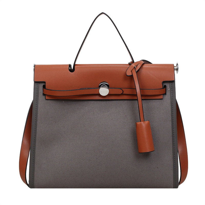 Nicho de moda portátil Kelly bolso mujer 2026 nuevo cross-border lienzo empalme color contraste viaje mochila de hombro