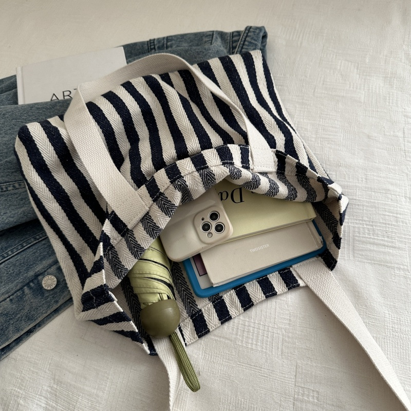 The new cross-border vertical striped commuter tote bag, hand-held shoulder bag, is fashionable and has a large capacity. It features an InS-style simple letter sail undefined