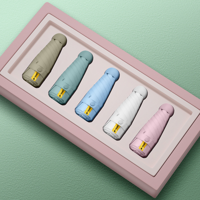 50% de descuento paraguas de cápsula de seis huesos paraguas de Sol de doble uso pequeño paraguas de bolsillo portátil simple pegamento negro paraguas de protección solar al por mayor