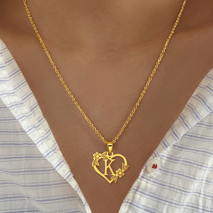golden pendant with letters heart shaped