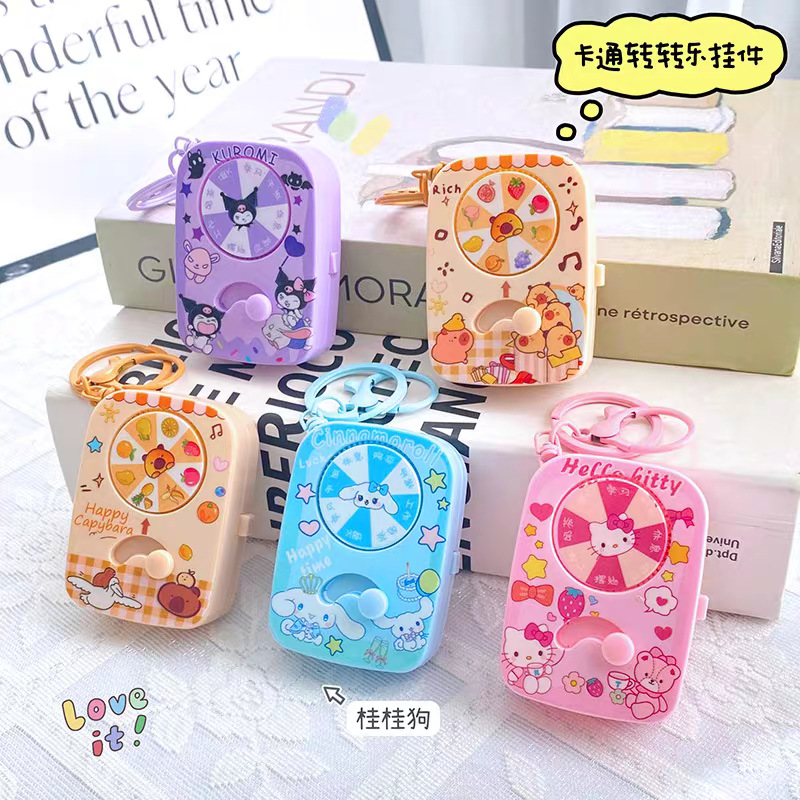 Creativo Sanrio juego giratorio luminoso giratorio alejo dedos juguetes de compresión de bolsas escolares colgantes llaveros