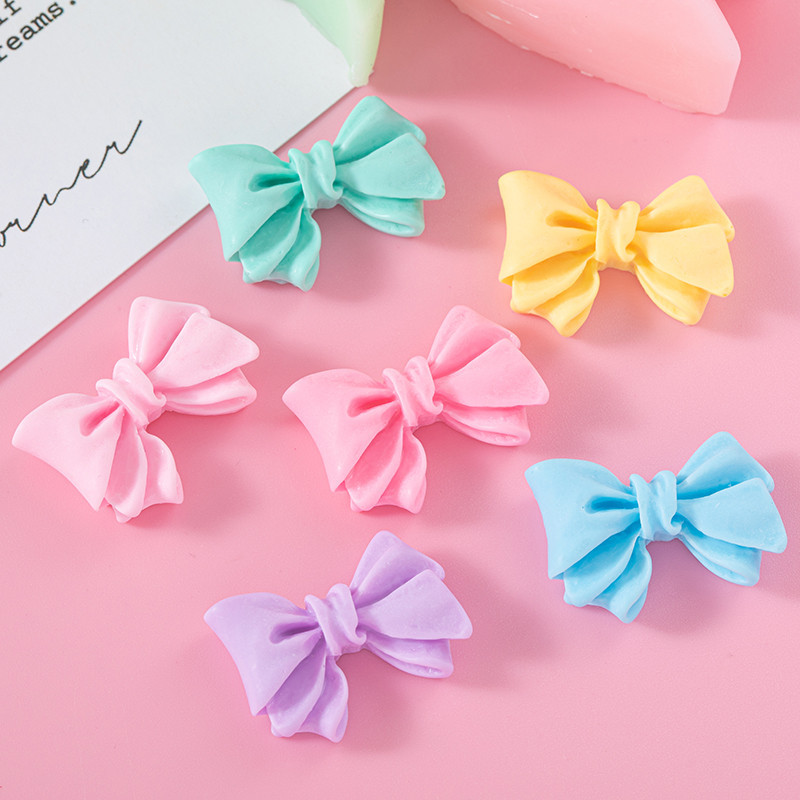 Accesorios de resina de arco de color macaron DIY Crema Accesorios de cuerda de cabello de agujero de caja de teléfono móvil Colgante de hebilla de zapato