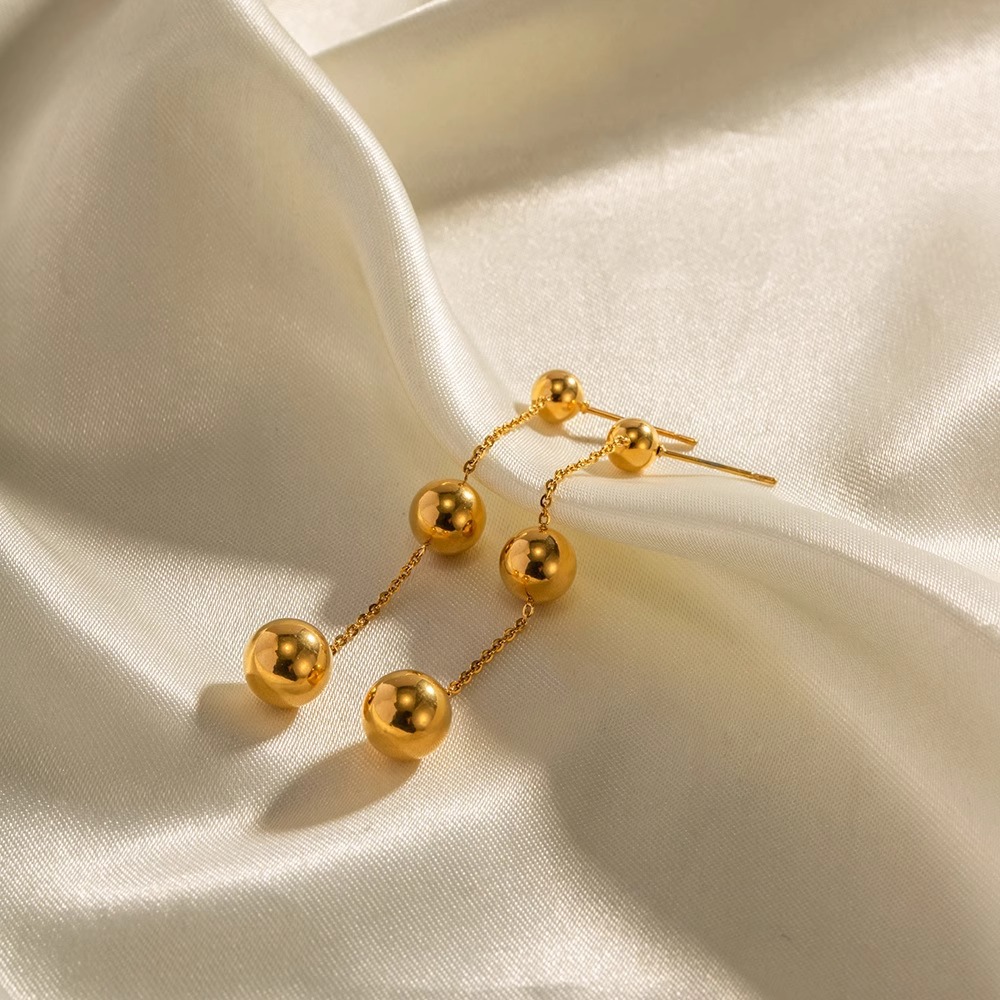 Elegant display of Gold Titanium Steel Solid Ball Stud Earrings