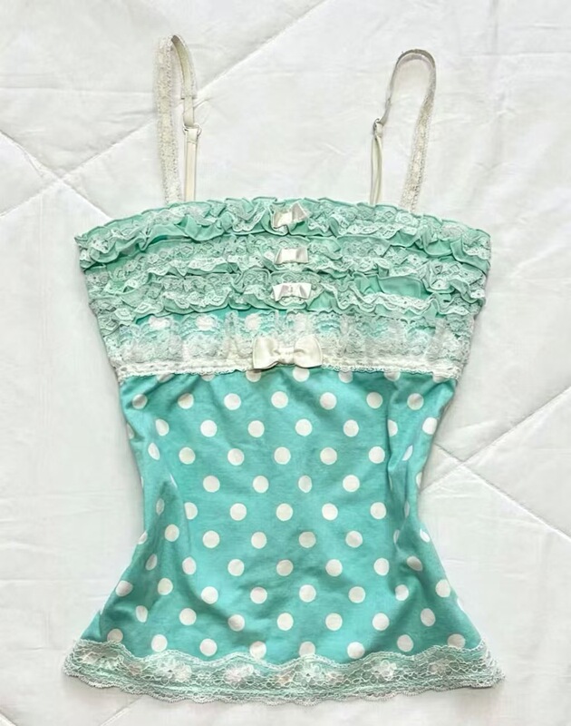 Mint green polka dot lace trim camisole, multi-layered ruffled design, small bow detail, slim-fit, sleeveless, and can be worn as a base layer Mint green polka dot lace trim camisole, multi-layered ruffled design, small bow detail, slim-fit, sleeveless, and can be worn as a base layer