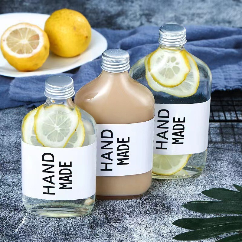 Transparent flat round sealed aluminum cap screw-top cold brew juice, milk tea, coffee, American-style glass water bottle packaging bottle