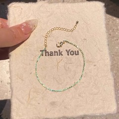 キラキラした極細緑色のジルコンのブレスレットの女性ins夏の大衆の精巧で高級なデザインは、手飾りの潮を重ねています。