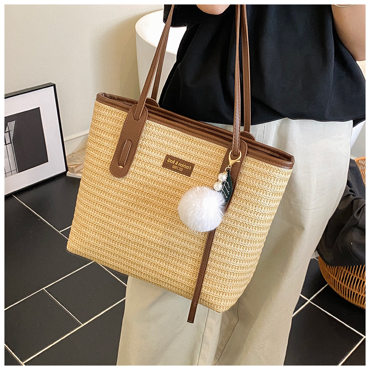 This is a new 2025 summer beach-style women's bag with a simple and versatile hand-held design. It's a single-shoulder vacation woven bag undefined
