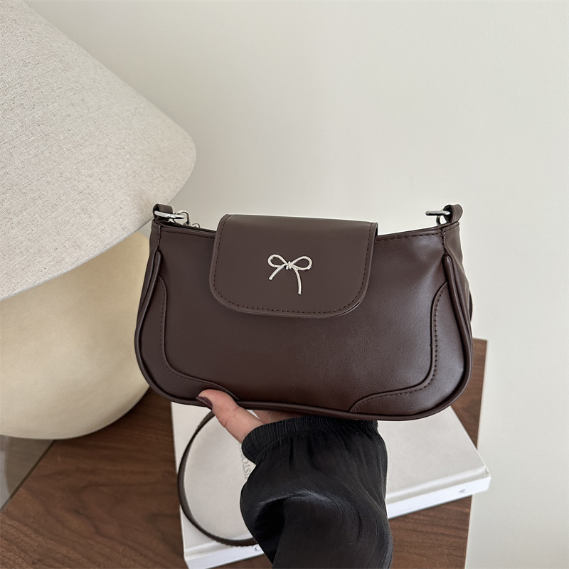 Bolsa de viaje retro para mujeres 2025, nueva moda, bolso de brazo de arco de moda, bolso de brazo elegante y dulce.