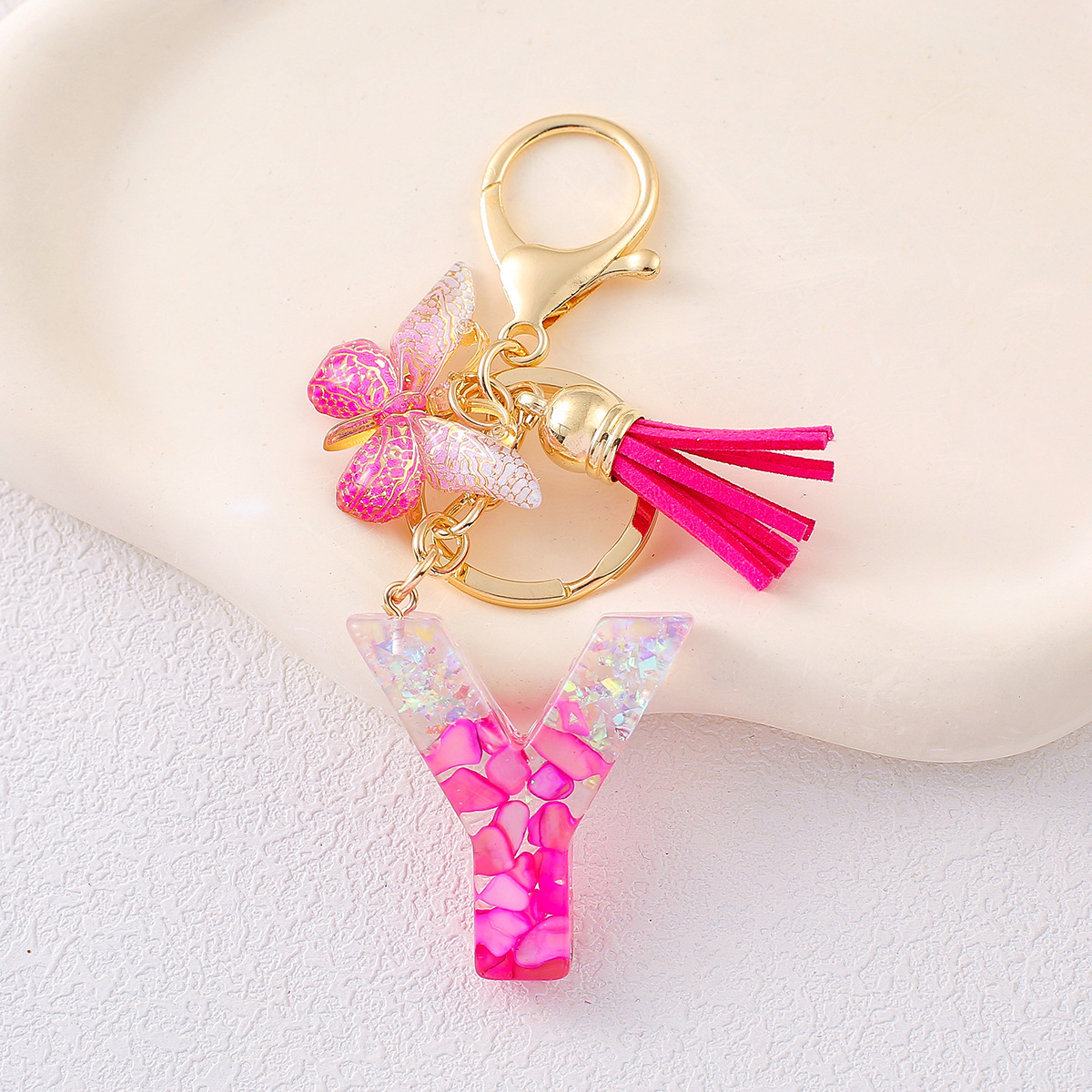 2024 explosión llavero joyería de resina letras bolsos colgantes de dama conchas rojas llavero colgantes de mariposa