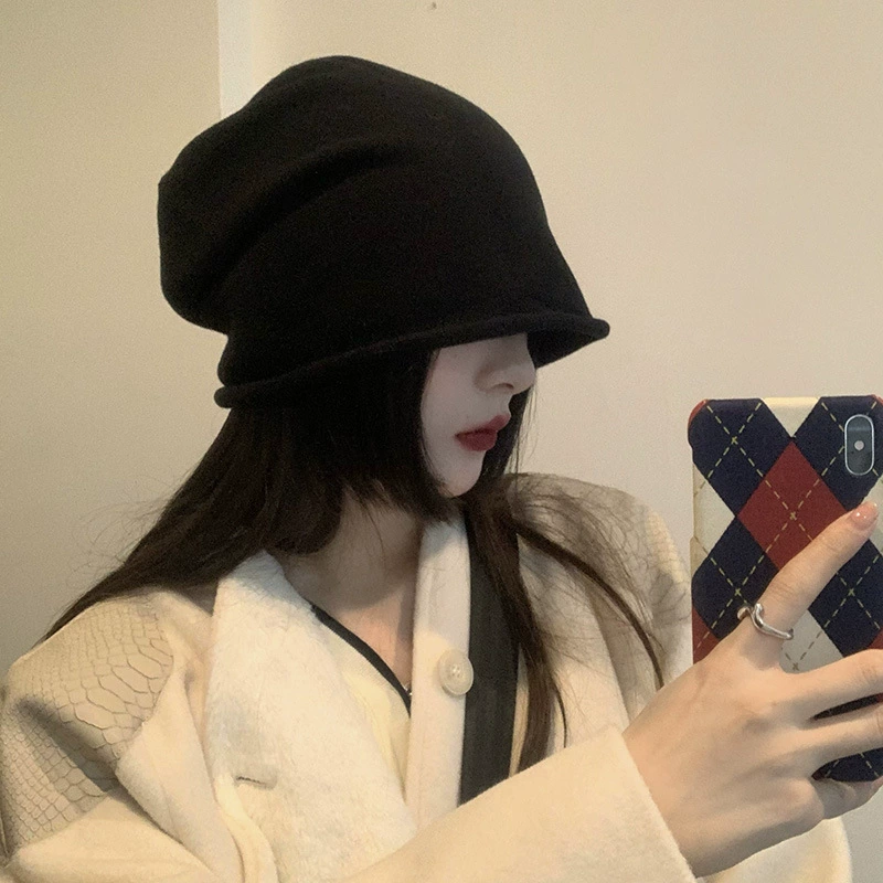 Winter knitted woolen capacious hat with hood, cut