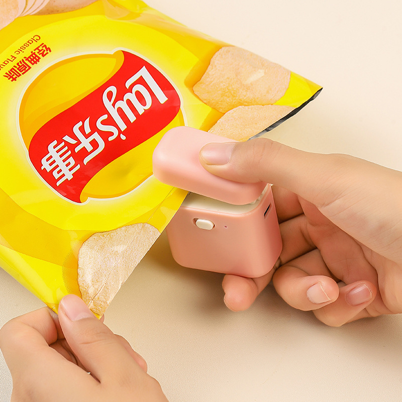 Mini encantadora máquina de sellado pequeña nevera doméstica absorción de bocadillos bolsas de plástico de alimentos frescos sellados artefactos de sellado