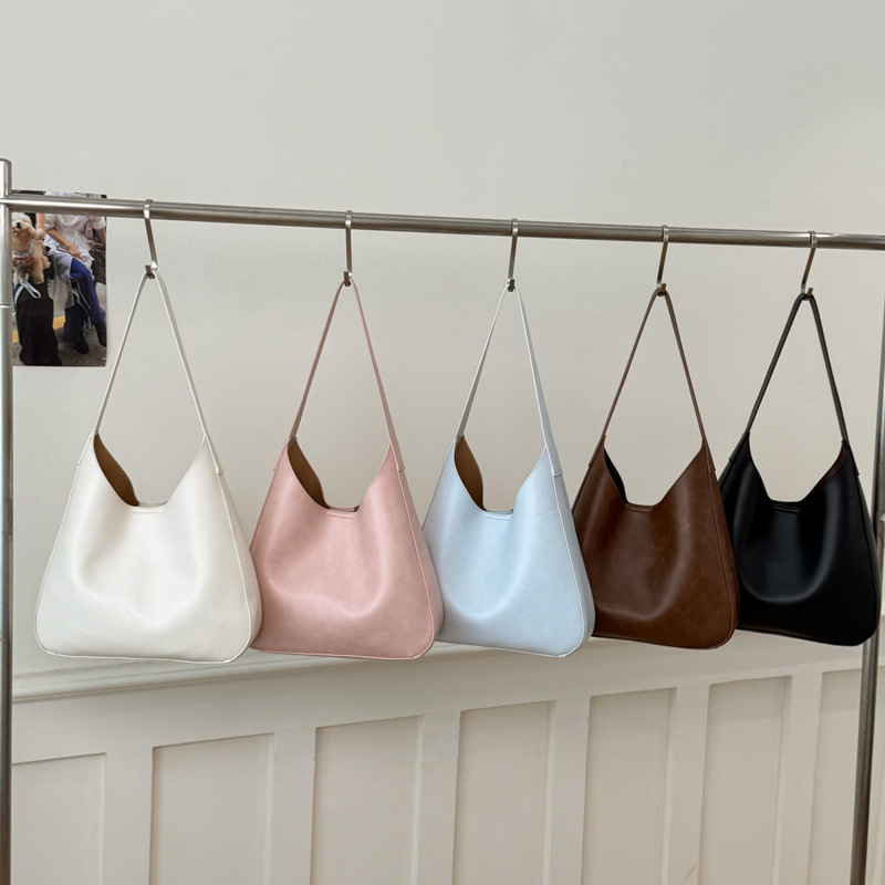 Nicho de diseño simple bolso de cubo portátil para mujeres 2026 primavera nueva moda perezosa retro bolso de brazo diario