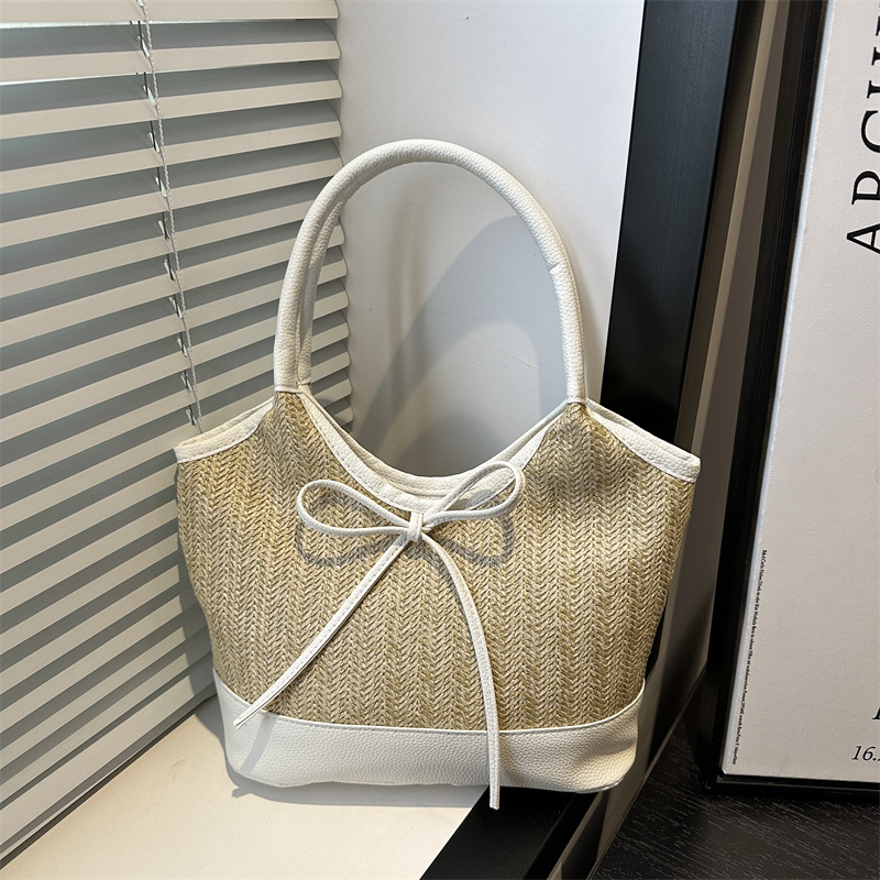 Verano 2025 bowknot axila bolso femenino moda casual bolso de mano de gran capacidad bolso de hombro de color de contraste de paja de nicho