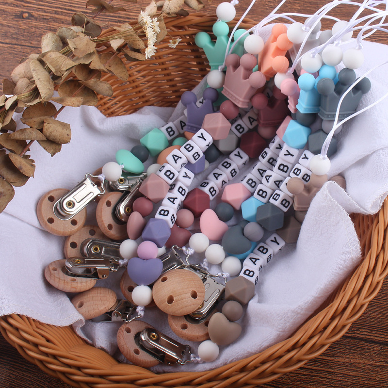 Nuevo bebé haya chupete clip calmante bebé corazón corona de silicona mordedura molar Cadena de chupete cadena anti-caída