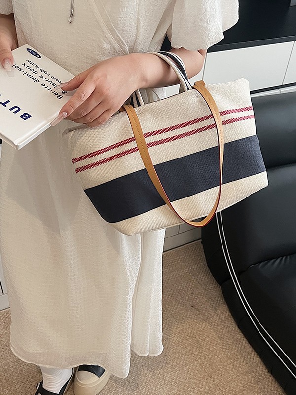 Versión coreana del bolso Tote a rayas a juego de color de gran capacidad para mujer 2025 nuevo bolso de hombro de estilo perezoso de textura occidental simple