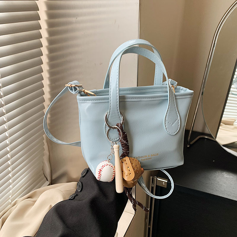 Bolso de cubo de textura de color sólido para mujer 2025 primavera nueva moda bolso de mensajero coreano estilo occidental de alta gama para mujer