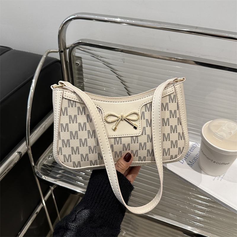 Tendencia universal bolso de hombro para mujeres 2025 nuevo estilo simple bolso de brazo de viaje de moda arco bolso de mano