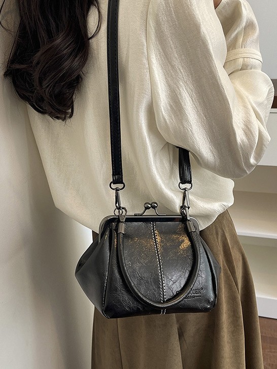 Bolso de conchas de moda para mujeres 2026 comercio exterior nuevo bolso coreano de abrazadera alta sensación retro versátil mochila