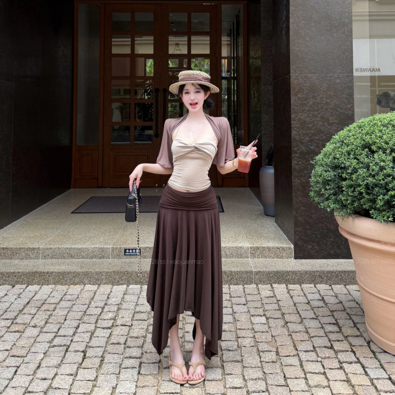 Vacation-style outfit: short cardigan, knotted halter neck camisole, and drapey skirt three-piece set for women in summer Vacation-style outfit: short cardigan, knotted halter neck camisole, and drapey skirt three-piece set for women in summer