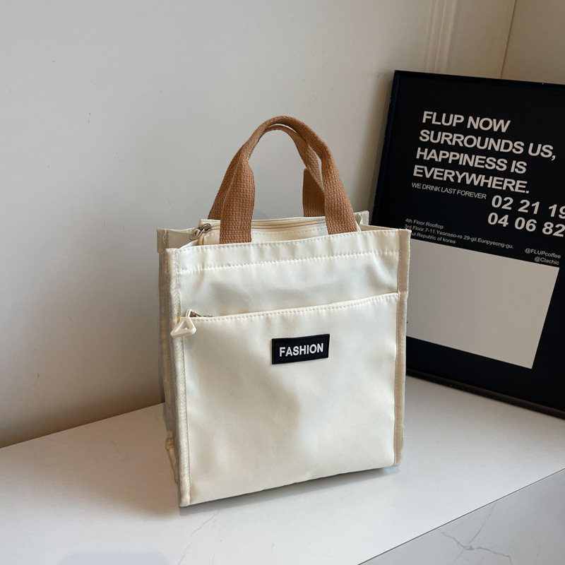 Moda coreana nueva serie de gran capacidad bolsas escolares portátiles de otoño 2024 bolsas de botellas impermeables Oxford