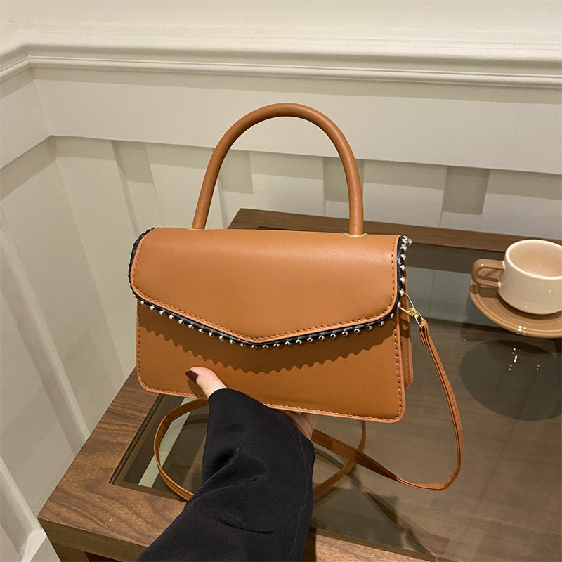 Bolso de hombro de aire extranjero para mujeres 2025 primavera nueva moda coreana portátil de color sólido simple bolso de tendencia