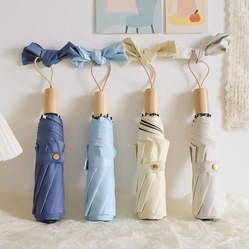 Solid color solid wood handle three folding umbrella simple fashion rain dual-use black glue folding umbrella High-looking sun-proof sun-proof umbrella