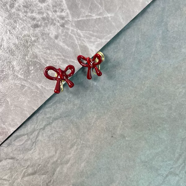 Red mosquito coil with bow, ear clips