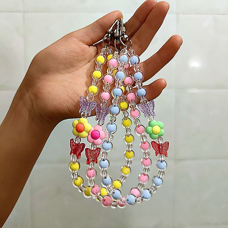 Flor Mariposa Caja del teléfono móvil Cadena con cuentas Douyin Bolso en vivo Auriculares Llavero Macaron Colgante Accesorios Cuerda