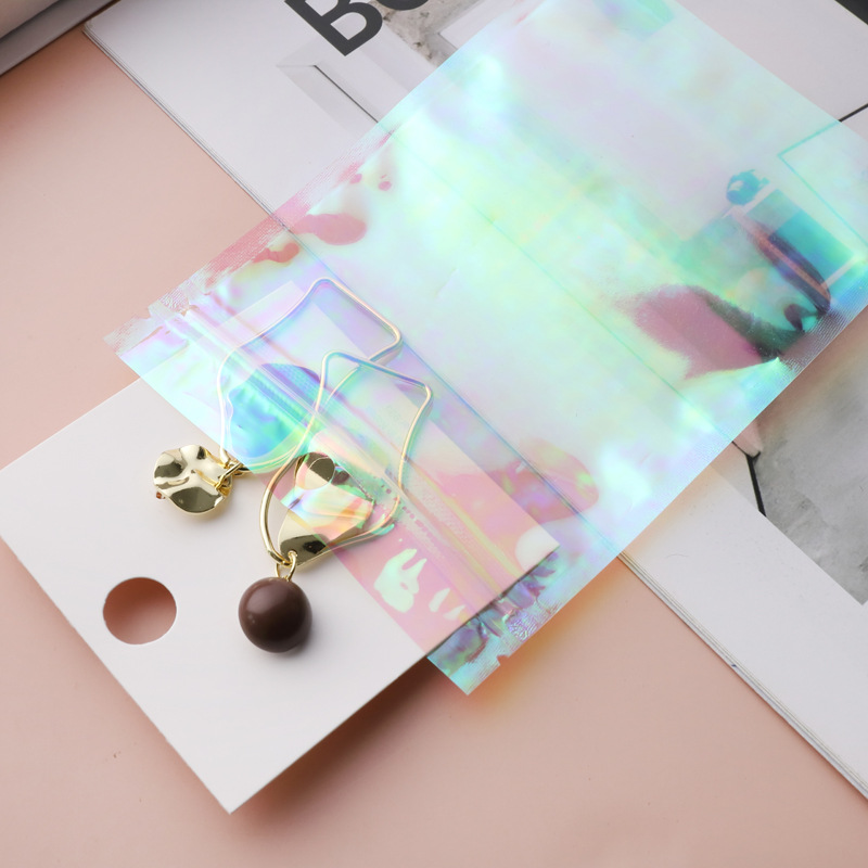 Pendientes de regalo de la joyería bolsa de embalaje bolsa de plástico transparente de color mágico sellado de color Iris láser ziplock bolsa en stock